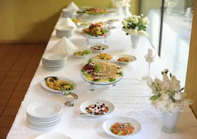 a long table with plates and desserts on it at Hotel Senas Namas in Alytus