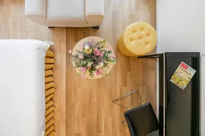 a living room with a flower arrangement on the wall at Vilnius Apartments in Vilnius