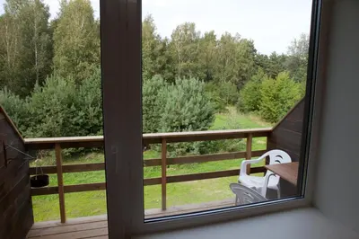 a window view of a balcony with a bench at Love Island 2 in Druskininkai