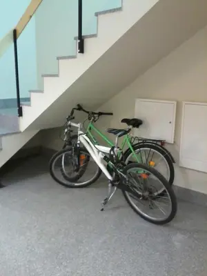 two bikes parked in a room under a staircase at Love Island 2 in Druskininkai