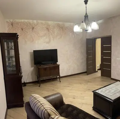 a living room with a couch and a flat screen tv at Gintautas apartment in Šiauliai