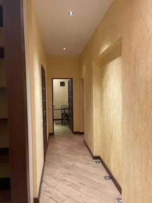 an empty hallway with a hallway leading to a room at Gintautas apartment in Šiauliai