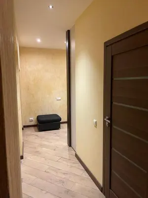 a hallway with a door and a couch in a room at Gintautas apartment in Šiauliai