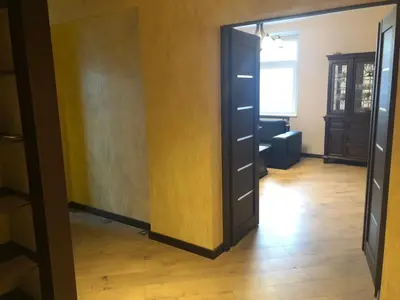 a hallway with a door open to a room at Gintautas apartment in Šiauliai
