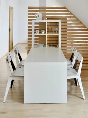 a white table and chairs in a room at Draugų namai in Druskininkai
