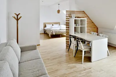 a living room with a couch and a table at Draugų namai in Druskininkai