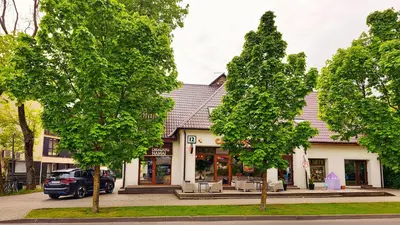 a building with a car parked in front of it at Draugų namai in Druskininkai