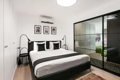 a bedroom with a bed and a glass wall at Luxury for everyone - Hills Park Lux Apartments 2 in Vilnius