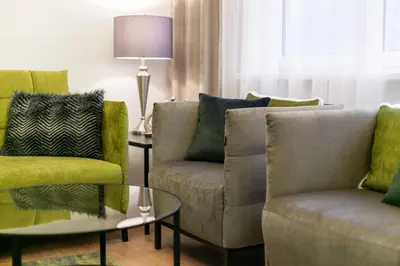 a living room with two chairs and a table at Luxury for everyone - Hills Park Lux Apartments 2 in Vilnius