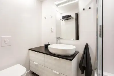 a white bathroom with a sink and a toilet at Luxury for everyone - Hills Park Lux Apartments 2 in Vilnius