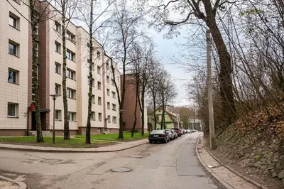 a car parked on a street next to a building at Luxury for everyone - Hills Park Lux Apartments 2 in Vilnius