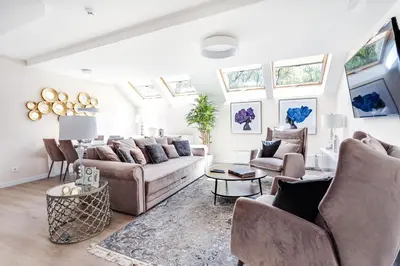 a living room with a couch and chairs and windows at Luxury for everyone - Hills Park Lux Apartments 1 in Vilnius