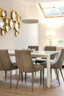 a dining room with a white table and chairs at Luxury for everyone - Hills Park Lux Apartments 1 in Vilnius