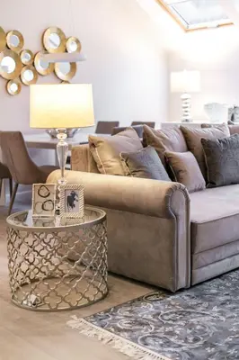 a living room with a couch and a table with a lamp at Luxury for everyone - Hills Park Lux Apartments 1 in Vilnius