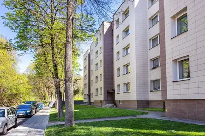 a building with cars parked in front of it at Luxury for everyone - Hills Park Lux Apartments 1 in Vilnius