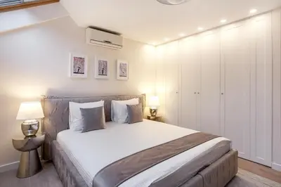 a bedroom with a large bed with white walls at Luxury for everyone - Hills Park Lux Apartments 1 in Vilnius