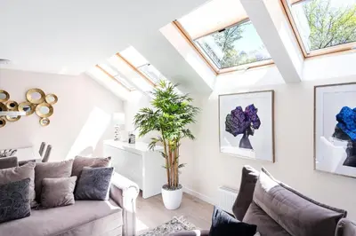 a living room with a couch and skylights at Luxury for everyone - Hills Park Lux Apartments 1 in Vilnius