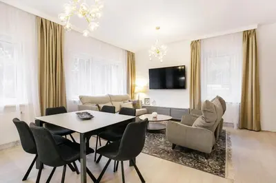 a living room with a table and chairs at Luxury for everyone - Hills Park Lux Apartments 3 in Vilnius