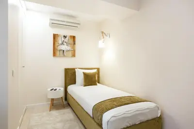 a bedroom with a bed in a white room at Luxury for everyone - Hills Park Lux Apartments 3 in Vilnius