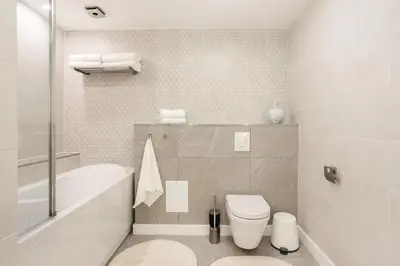 a bathroom with a tub and a toilet and a sink at Luxury for everyone - Hills Park Lux Apartments 3 in Vilnius