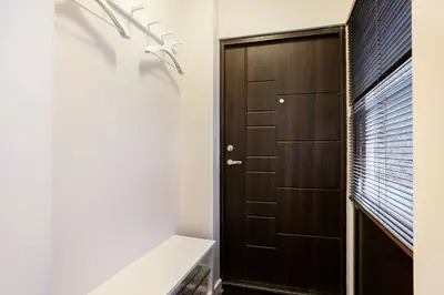 a bathroom with a wooden door and a white bench at Luxury for everyone - Hills Park Lux Apartments 3 in Vilnius