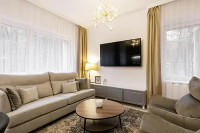 a living room with a couch and a table at Luxury for everyone - Hills Park Lux Apartments 3 in Vilnius