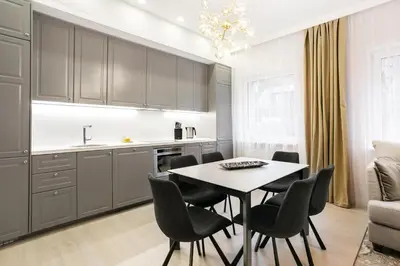 a kitchen and dining room with a table and chairs at Luxury for everyone - Hills Park Lux Apartments 3 in Vilnius