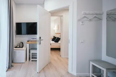 a room with a door open to a room with a desk at J14A I Rooms & Apartments AUTOMATED SELF CHECK-IN in Vilnius