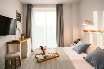 a hotel room with a bed with a tray of towels at J14A I Rooms & Apartments AUTOMATED SELF CHECK-IN in Vilnius