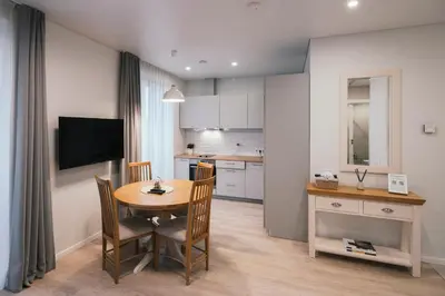 a kitchen and dining room with a table and chairs at J14A I Rooms & Apartments AUTOMATED SELF CHECK-IN in Vilnius
