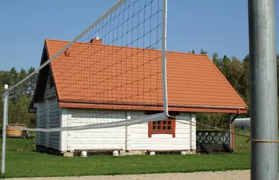 a large white building with an orange roof at Sodyba pas Olgą in Mickūnai