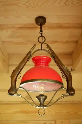 a red chandelier hanging from a ceiling at Sodyba pas Olgą in Mickūnai