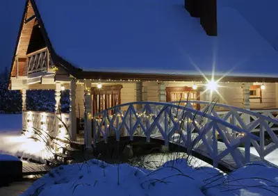 a bridge over a pond in front of a house at Sodyba pas Olgą in Mickūnai