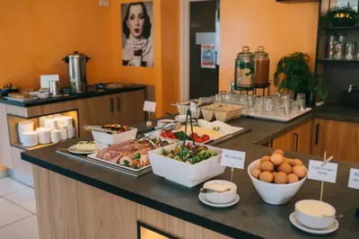 a buffet with food on a counter in a restaurant at Sanatorija ,,Tulpės