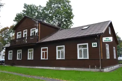 a brown house with a balcony on top of it at Vila Evelina in Druskininkai