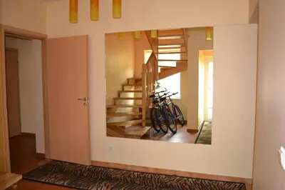 a mirror on the wall of a room with a bike on it at Vila Evelina in Druskininkai