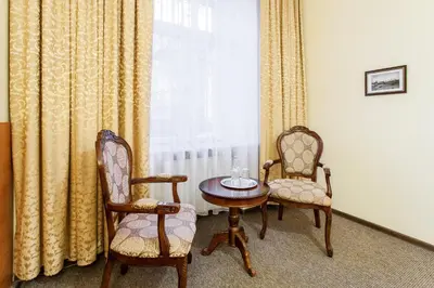 a room with two chairs and a table and a window at Silvija House in Vilnius
