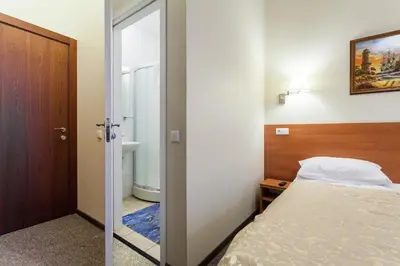 a bedroom with a bed and a sliding door at Silvija House in Vilnius