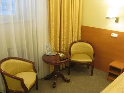 a room with two chairs and a table and a bed at Silvija House in Vilnius