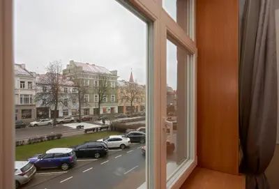 a window with a view of a city street at Town Hall Apartments in Vilnius