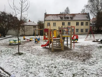 a playground in a yard covered in snow at Town Hall Apartments in Vilnius