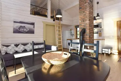 a living room with a table and a couch at Mekų vila in Degučiai