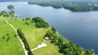 an aerial view of a house on a hill next to a lake at Mekų vila in Degučiai