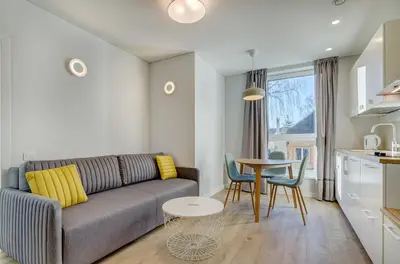 a living room with a couch and a table at Center Apartment 10A in Vilnius
