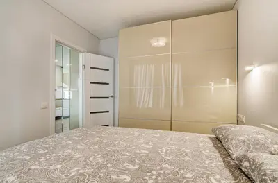a bedroom with a bed and a closet at Center Apartment 10A in Vilnius