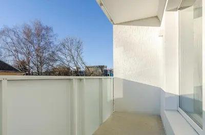 a room with a white wall and a window at Center Apartment 10A in Vilnius
