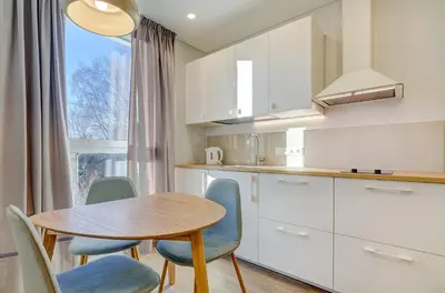 a kitchen with a table and chairs and a window at Center Apartment 10A in Vilnius