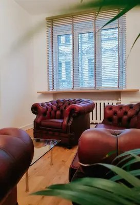 a living room with two leather couches and a window at Islandijos gatvė in Vilnius