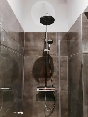 a bathroom with a shower with a glass door at Islandijos gatvė in Vilnius