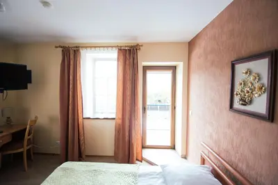 a bedroom with a bed and a window and a desk at Svečių namai Lingės in Nemėžis
